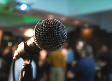 Microphone with a blurred background featuring a conference setting