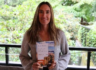 Image of Professor Emily Kennedy holding her book