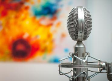 Microphone against a backdrop with colorful paint