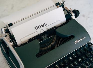 Typewriter and paper with the word &amp;quot;News&amp;quot;